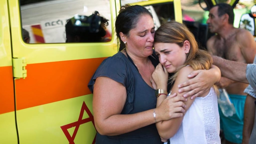 Israelis react after a rocket, fired by Palestinian militants in Gaza, landed in the southern city of Ashkelon. Photograph: Reuters/Amir Cohen