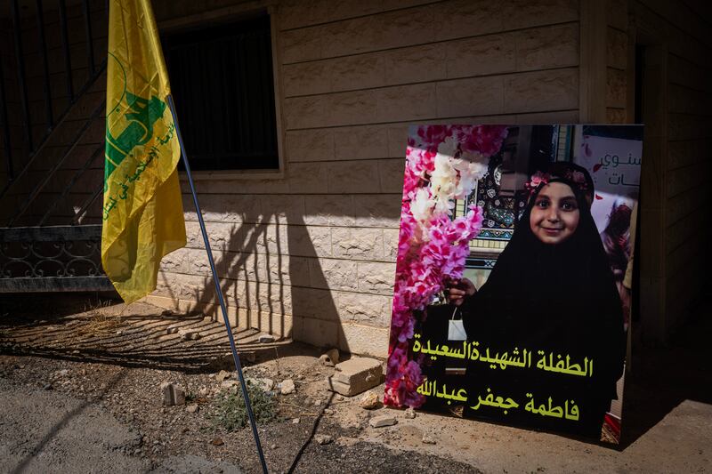A photograph of Fatima Abdullah, the nine-year-old girl among those killed in the pager attack, outside the cemetery where she was buried in Saraain El Faouqa, Lebanon on Wednesday. Photograph: Diego Ibarra Sánchez/New York Times