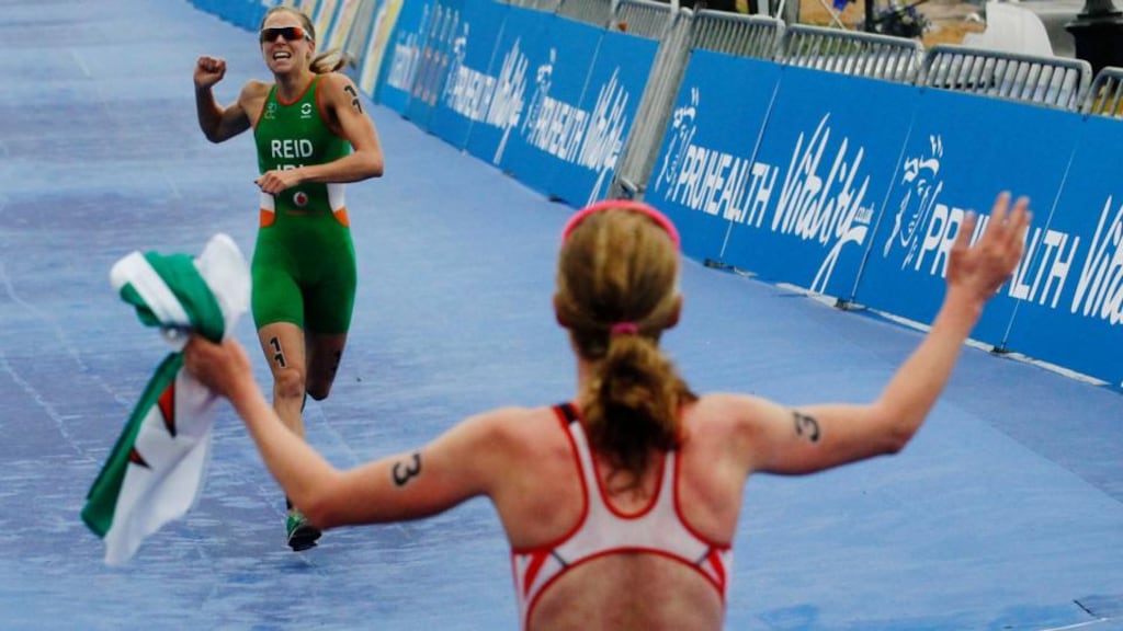 Race winner Non Stanford of Britain cheers home silver medal winner Aileen Reid from Ireland at the ITU World Triathlon Series Grand Final at Hyde Park in London. Photograph: Luke MacGregor/Reuters