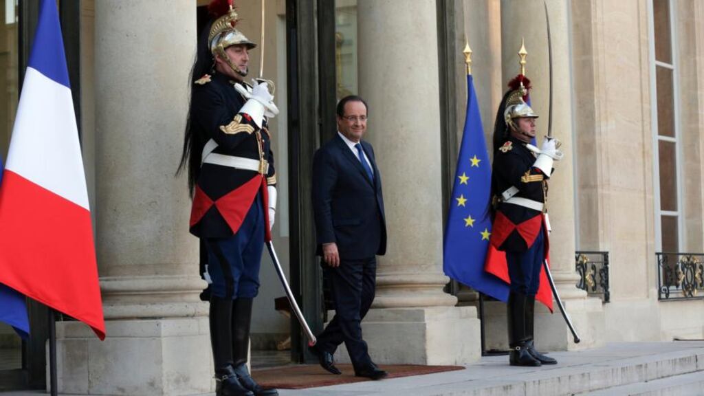 French President François Hollande waits for a guest on the steps at the Elysee Palace in Paris. With approval ratings low, the Hollande administration is often accused of incompetence and inconsistency. Photograph: Philippe Wojazer/Reuters