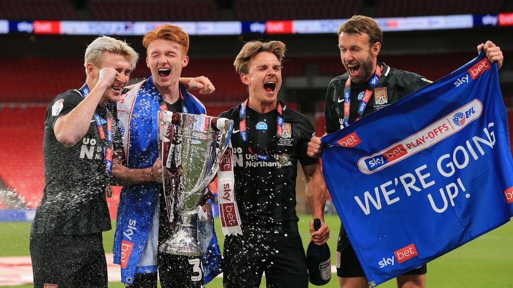Northampton Town players celebrate their recent promotion from League Two to League One. Photo: Leila Coker/MI News/NurPhoto via Getty Images
