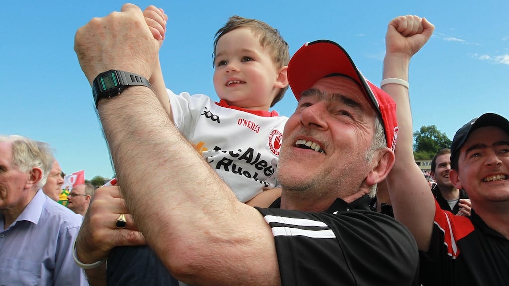 Tyrone’s Mickey Harte celebrates with his grandson Michael after the Ulster final victory over Donegal. Photograph: Lorraine O’Sullivan/Inpho