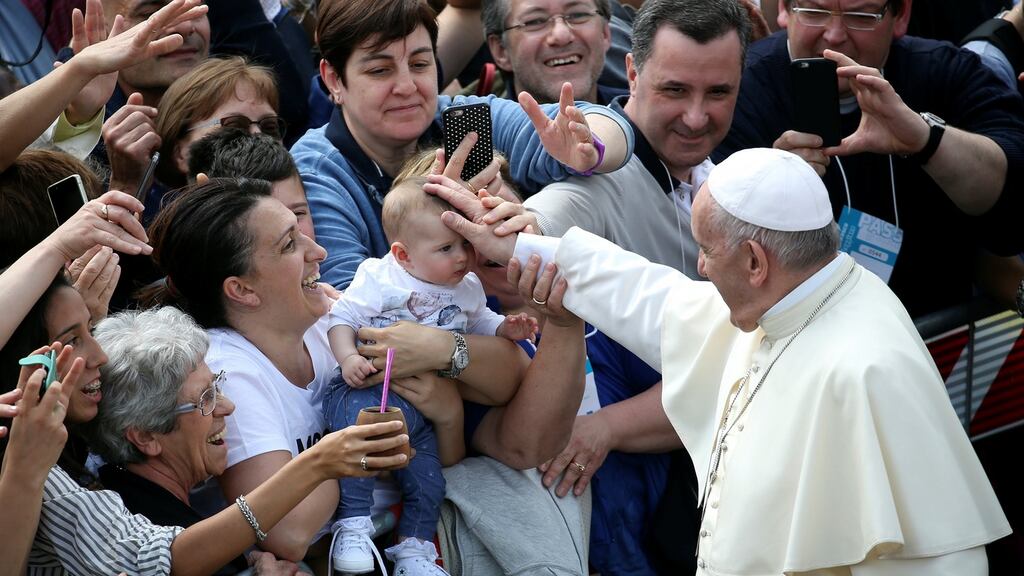 Pope Francis blesses a child at the end of his pastoral visit in Loppiano, central Italy. Photograph: Alessandro Bianchi/Reuters