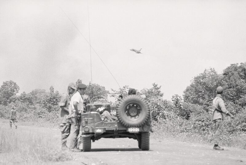 An American F-100 jet comes in low to drop napalm on communist positions near the town of Skoun, Cambodia, in August 1970. Photograph: Bettman Archive/Getty Images