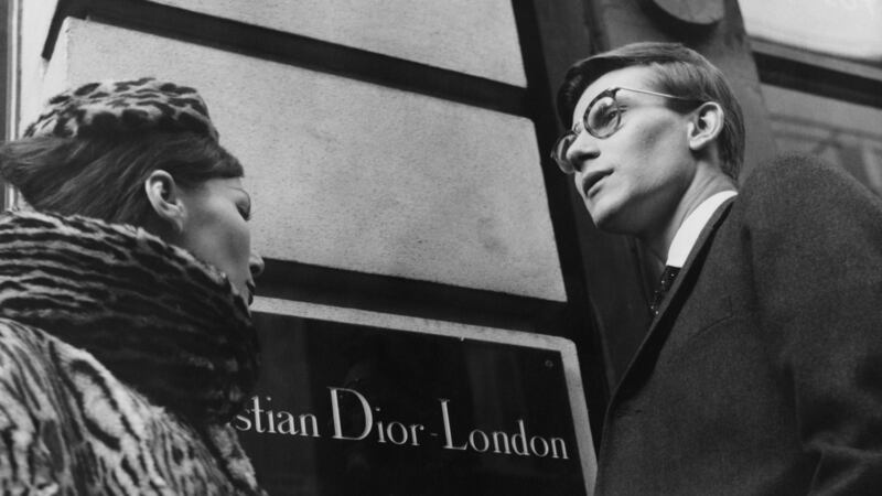 French fashion designer Yves Saint Laurent (1936 - 2008) in London, 11th November 1958. He is preparing for the following day’s Dior Autumn collection show to an audience including Princess Margaret, at Blenheim Palace. Photograph: Popperfoto/Getty Images