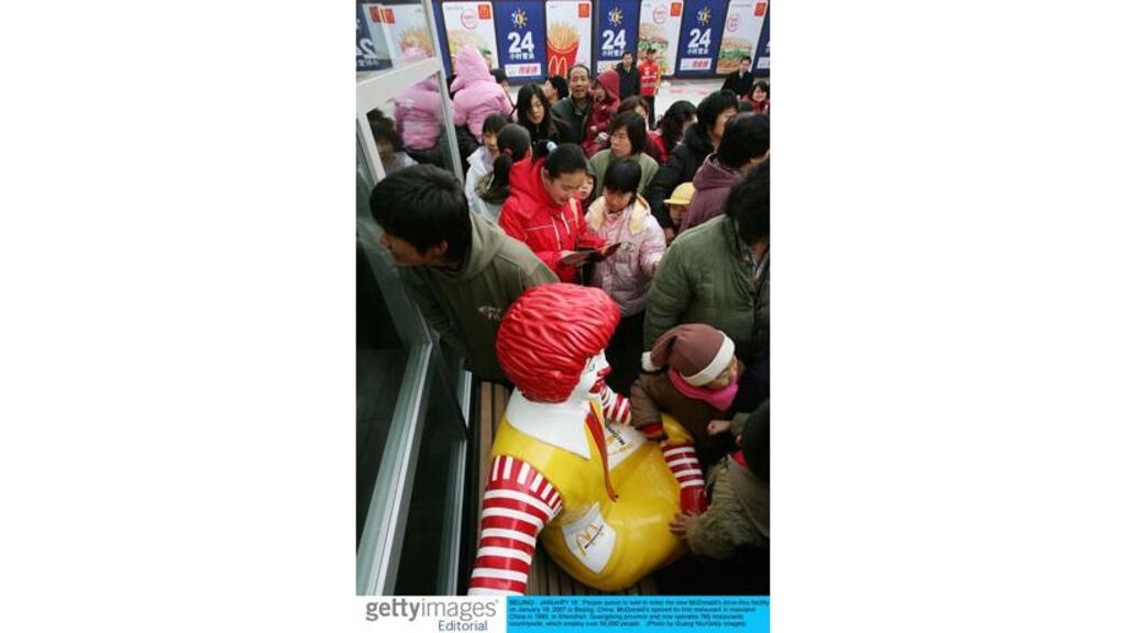 People queue to enter a new McDonalds in Beijing, China: Ongoing
industrialisation in China and India has spurred global demand for
commodities, according to NCB