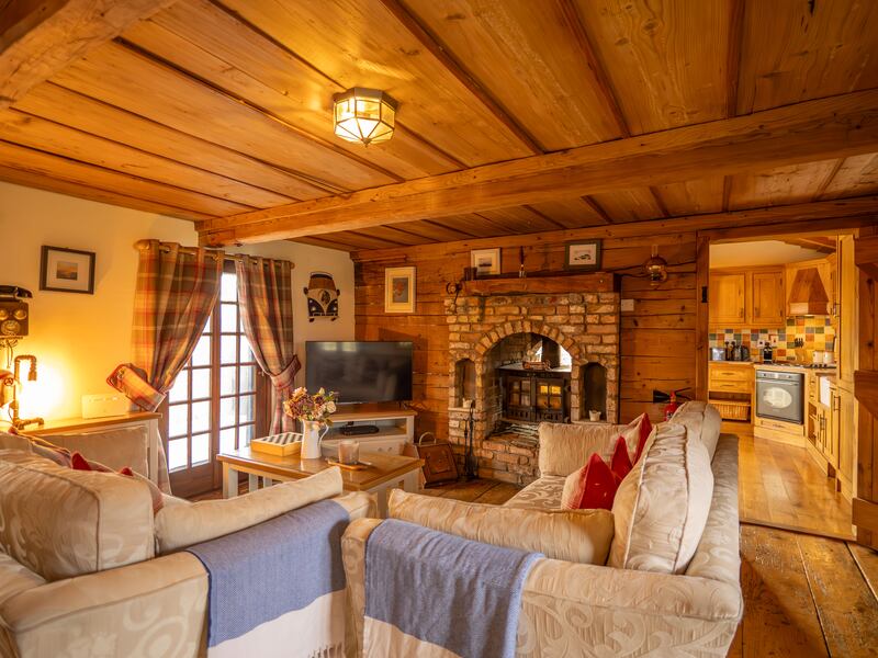 The sittingroom is set around a brick-surround wood-burning stove