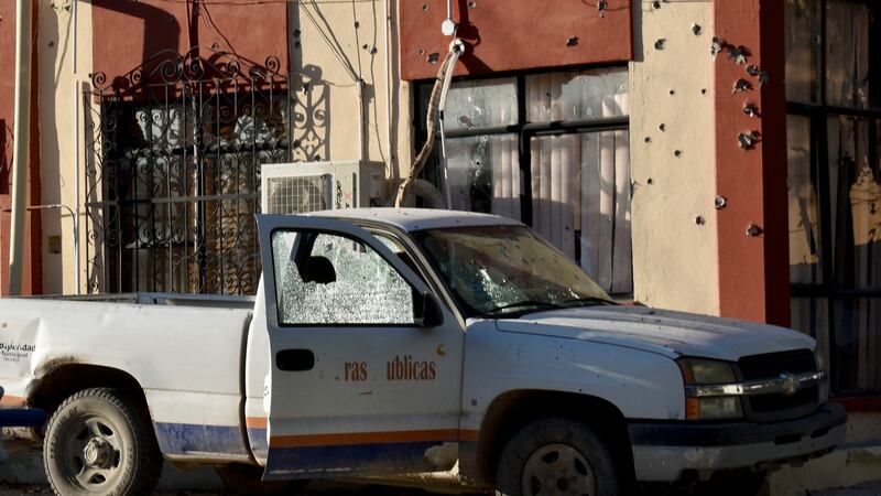 A damaged vehicle is parked at the City Hall of Villa Union, Mexico, after a gunbattle between Mexican security forces and suspected cartel members on Saturday. Photograph: AP/Gerardo Sanchez