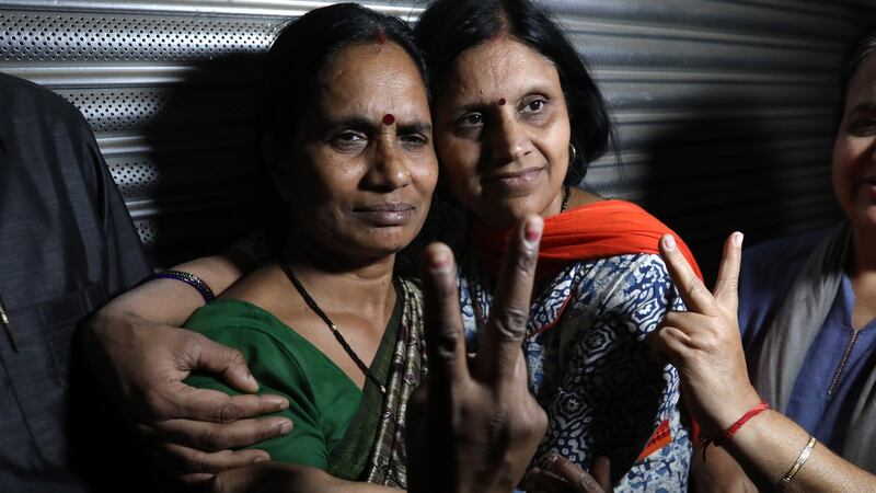 The mother (left) of the 2012 murder and gang rape victim after the hanging of the convicted attackers in New Delhi. Photograph: Rajat Gupta/EPA