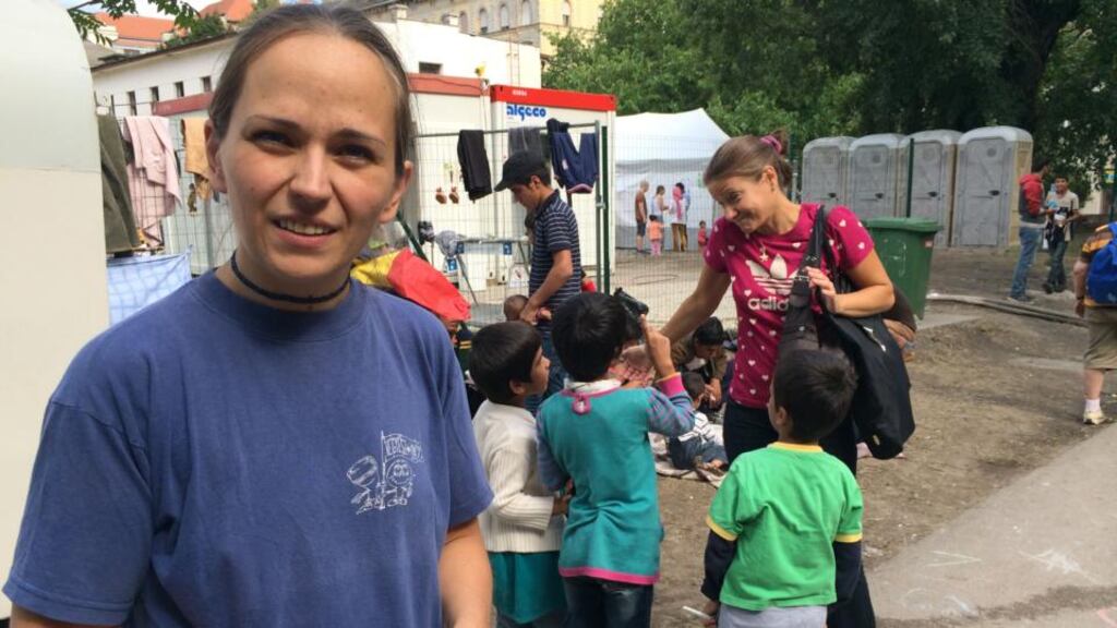 Zsuzsanna Zsohar, of Migration Aid, helps migrants at Nyugati station, Budapest. Photograph: Daniel McLaughlin