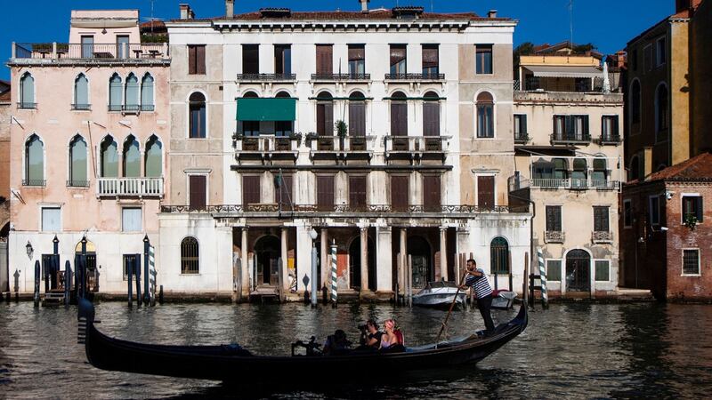 People enjoy a gondola ride in Venice. Photograph: Tiziana Fabi/AFP via Getty Images