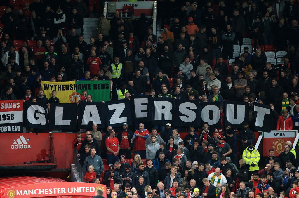 Manchester United fans hold a banner reading "Glazers Out" ahead of the English League Cup third-round match against Aston Villa at Old Trafford. Photograph: Lindsey Parnaby/AFP via Getty Images