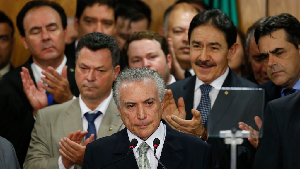 Brazil’s interim president Michel Temer (centre) attends a signing ceremony for his new government ministers at the Planalto presidential palace after the Senate voted to accept impeachment charges against suspended president Dilma Rousseff. Photograph: Igo Estrela/Getty Images.