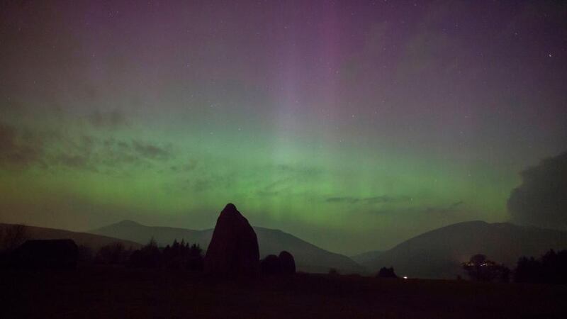 The aurora borealis, or the northern lights as they are commonly known, at Castlerigg Stone Circle in the Lake District, with Blencathra and Skiddaw behind. Photograph: Tom White/PA Wire