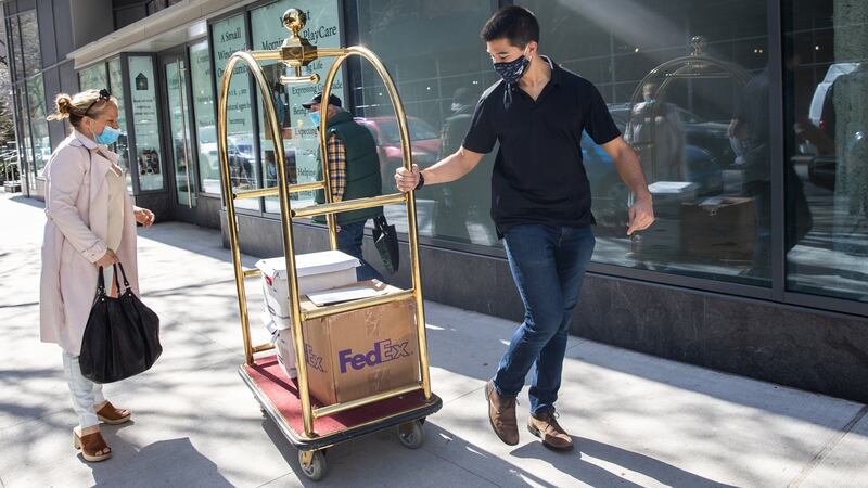 A district attorney investigator carries boxes of documents and a laptop from Jennifer Weisselberg (left) outside her apartment in Manhattan, New York, on April 8th. Photograph: Jeenah Moon for the Washington Post via Getty Images