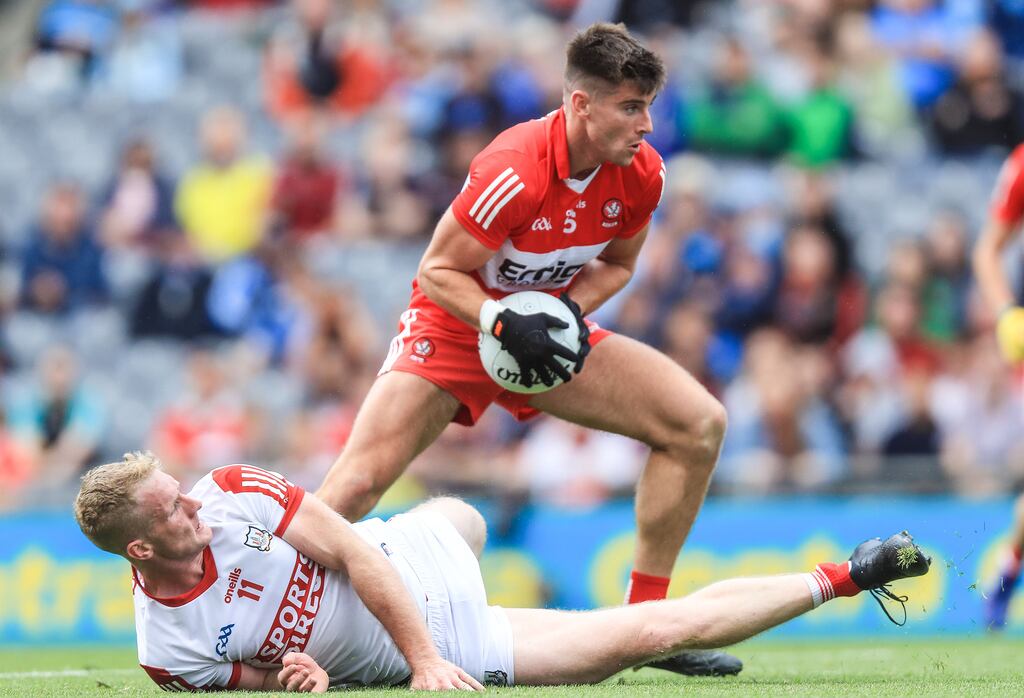 Derry's Conor Doherty leaves Cork's Ruairí Deane on the ground with a dummy to score his goal. Photograph: Evan Treacy/Inpho