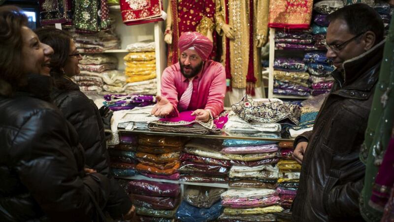 Jationder Pal Singh selling fabrics at his shop in the Little India neighborhood of Toronto