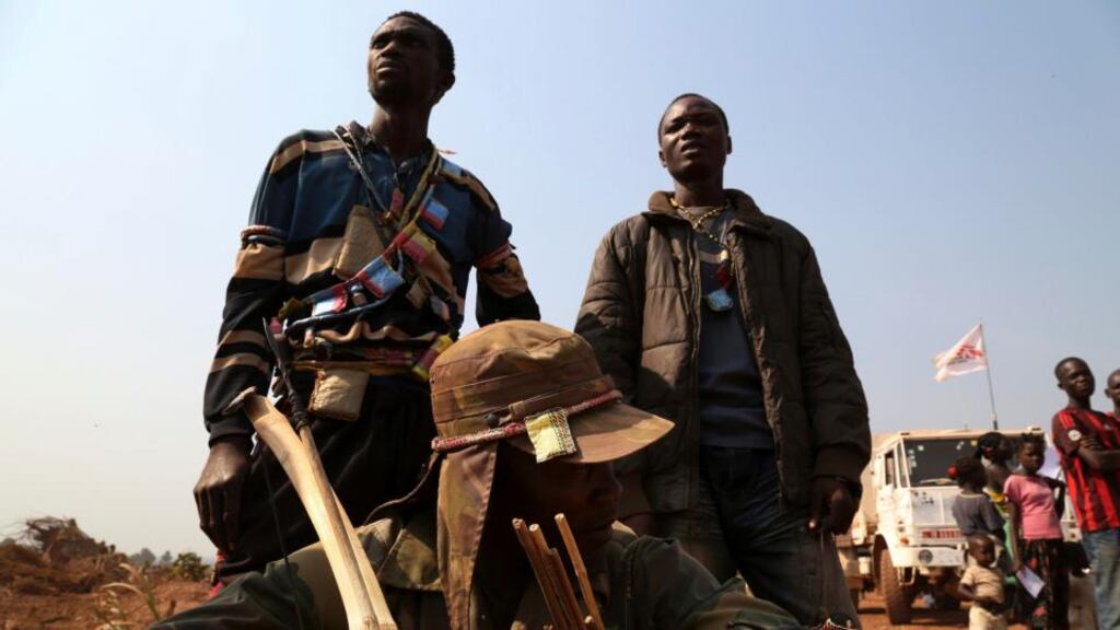A group of anti-balaka sentinels stand outside the Médecins Sans Frontière health centre in Bangui. Photograph: Emmanuel Braun/Reuters