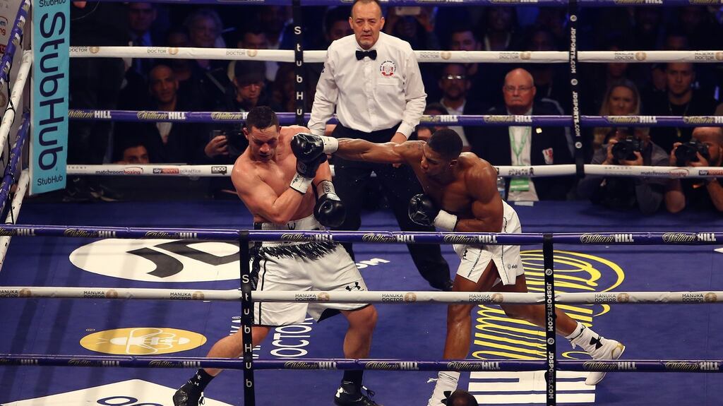 Anthony Joshua throws a right at Joseph Parker during their unifying heavyweight championship boxing title bout at the Principality Stadium in Cardiff on Saturday night. Photograph: Geoff Caddick/EPA
