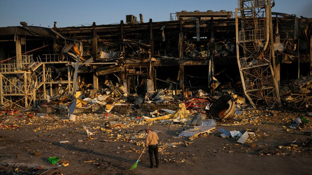 A man sweeps up rubble next to a shopping and entertainment mall destroyed after a Russian missile strike, in Odesa, Ukraine, on Friday. Photograph: Francisco Seco/AP Photo