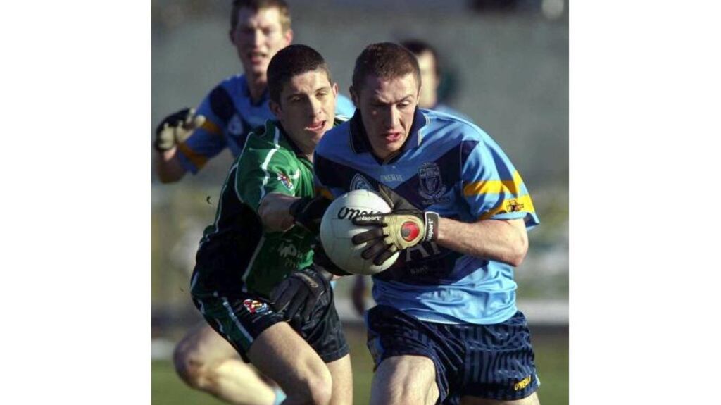 UCD's Billy Sheehan evades the tackle of Sean Kelly of QUB during yesterday's Sigerson Cup semi-final at Sarsfield Park in Belfast. Queen's University won the encounter, an Aidan Fegan goal sealing the Dublin college's fate. (Photograph: Andrew Paton/Inpho)