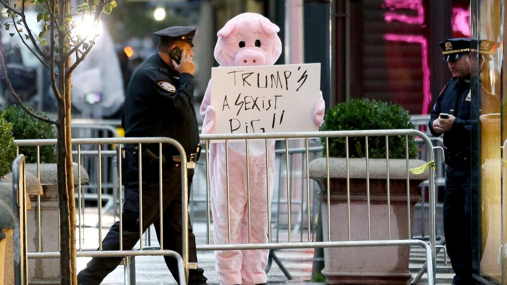Demonstrator outside Trump Tower in New York. Photograph: Seth Wenig/AP Photo