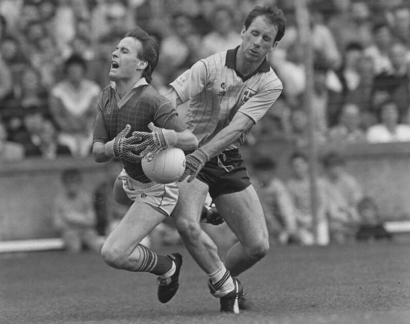 Bernard Flynn goes down under a challenge from Dublin's Michael Kennedy in the 1988 national Football League final. Photograph: Billy Stickland/Inpho