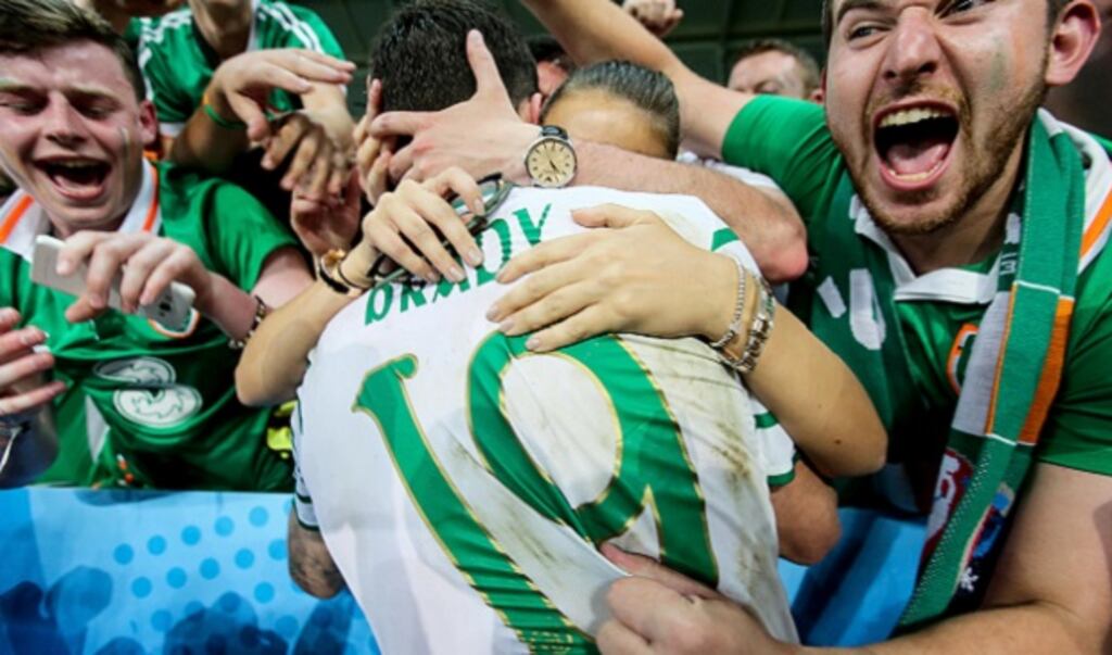 Robbie Brady celebrates with his girlfriend Kerrie Harris and supporters after the game. Photograph: Donall Farmer/Inpho