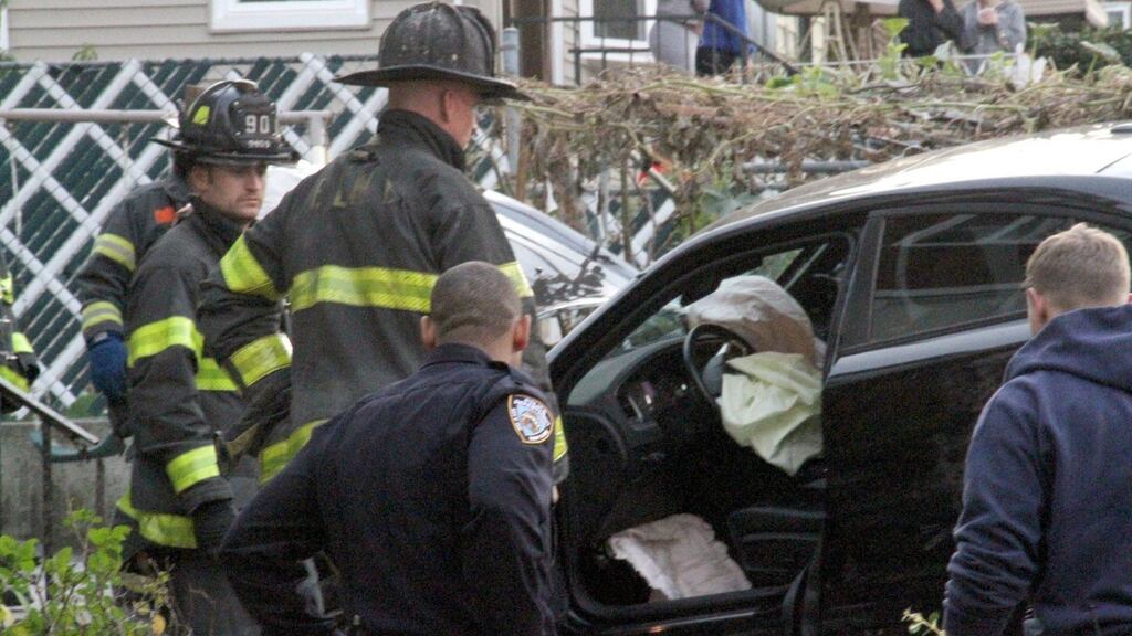 Emergency services examine a car that crashed into a group of trick-or-treaters in New York. Photograph: AP Photo/David Greene