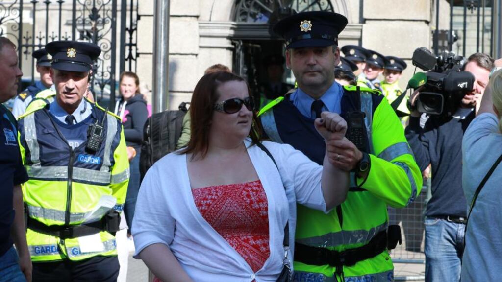 A protester is led away from the Dáil entrance during anti-water charge protests last night. Photograph: Nick Bradshaw