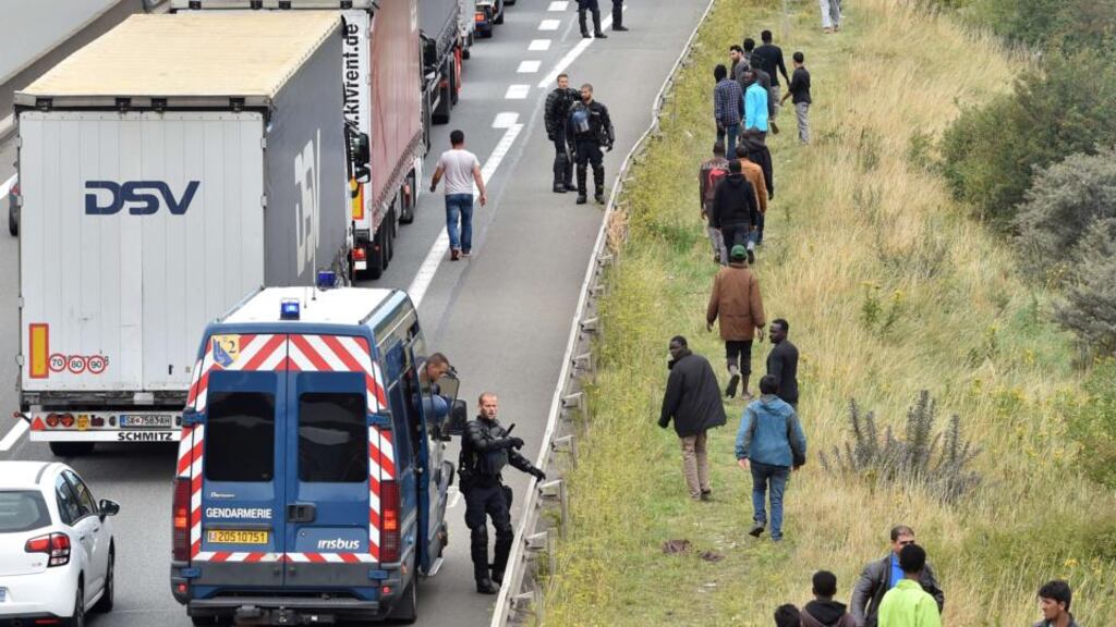 French riot police stand on the side of the road to prevent migrants from approaching lorries on the road leading to the ferry port in Calais, northern France. Photograph: AFP Photo