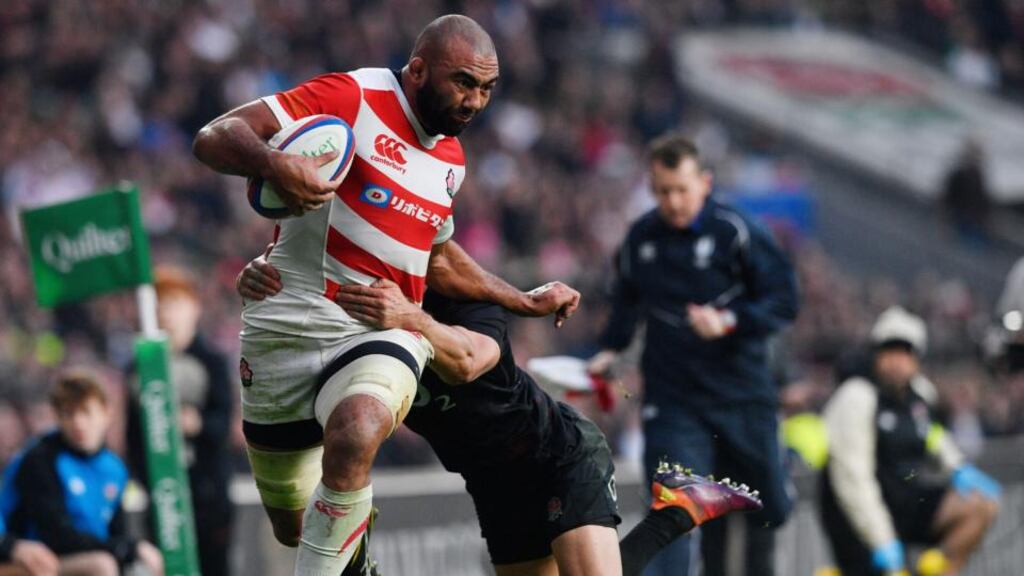 Japan’s Michael Leitch is tackled by England’s Alex Lozowki during the autumn international at Twickenham. Photograph: Neil Hall/EPA
