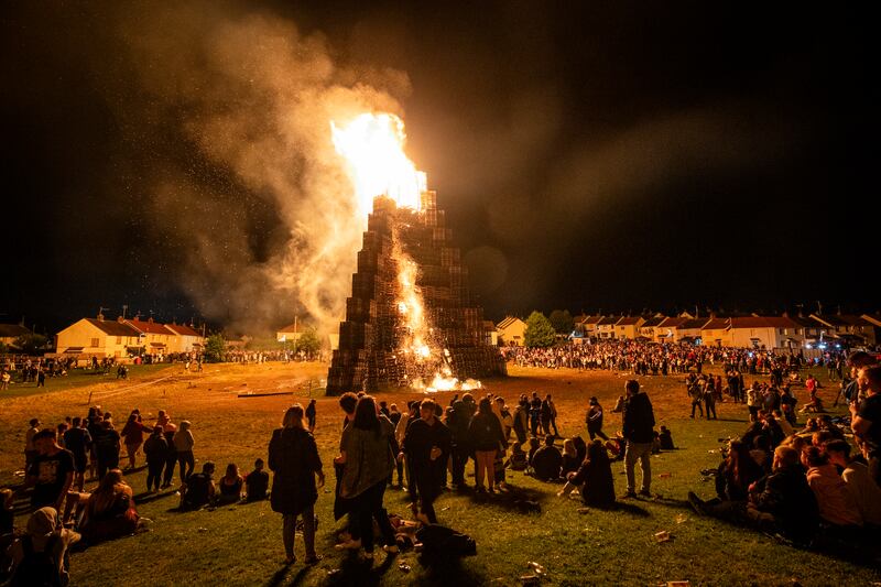People watch the burning of the loyalist Corcrain bonfire in Portadown, Co Armagh. Photograph: Liam McBurney/PA