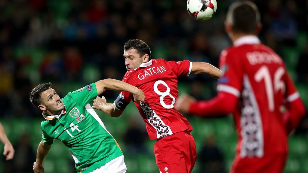 Wes Hoolahan in action against  Alexandru Gatcan of Moldova in Chisinau. Photograph: Ryan Byrne/Inpho