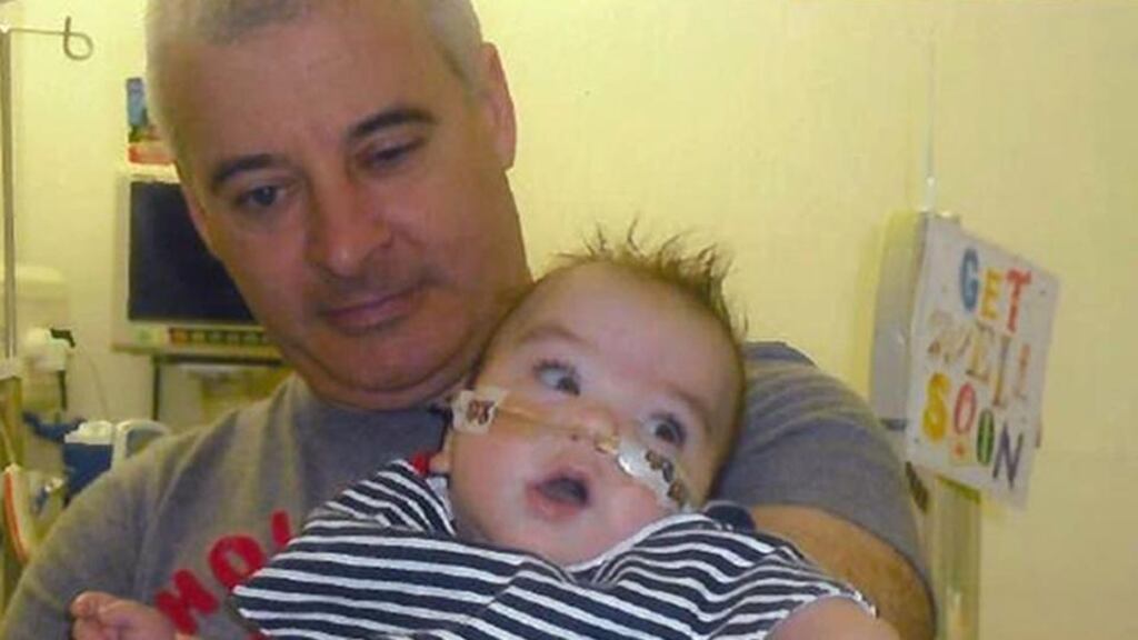 Undated family handout photo issued by PSNI of Kevin McGuigan with a then-hospitalised grandson in 2011. File photograph: Family handout/PSNI/PA Wire