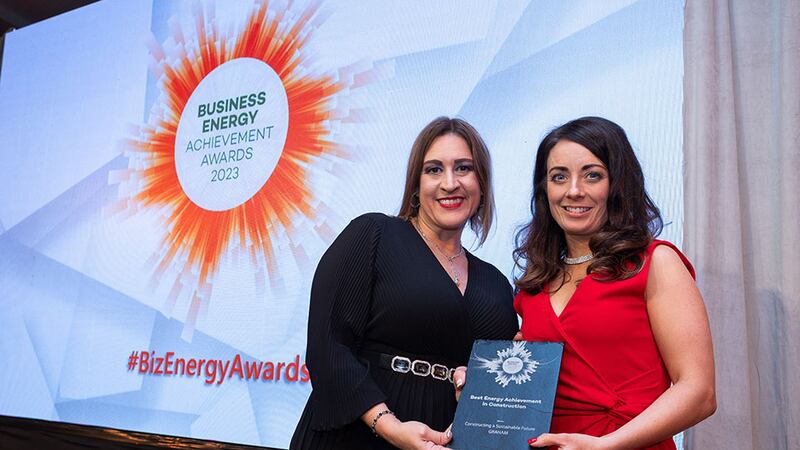 Katherine Valery, awards judge, presents the best energy achievement in construction award to Lianne Taylor, Graham
