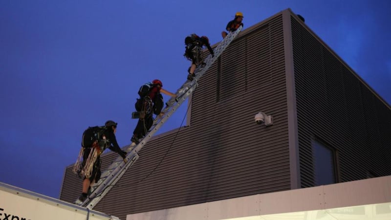 The climbers start their ascent of the  building. Photograph: David Sandison/Greenpeace/PA Wire