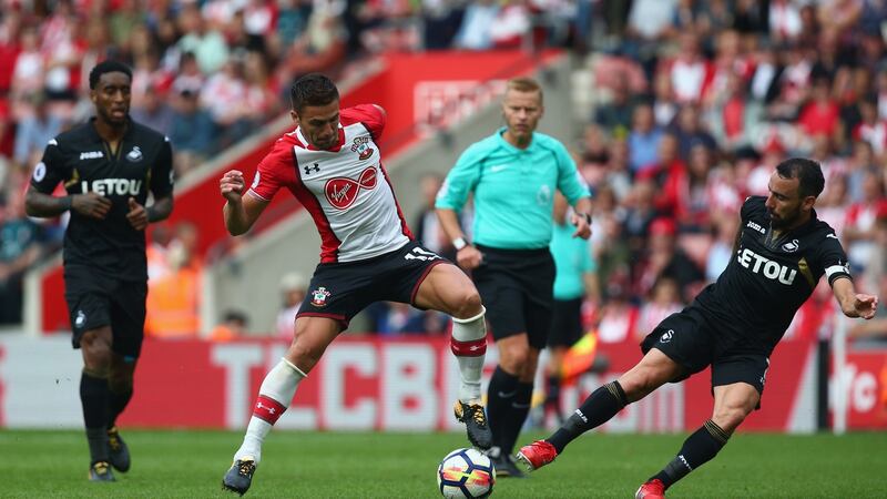 Dusan Tadic challenges Leon Britton during Southampton’s opening day draw with Swansea. Photograph: Charlie Crowhurst/Getty