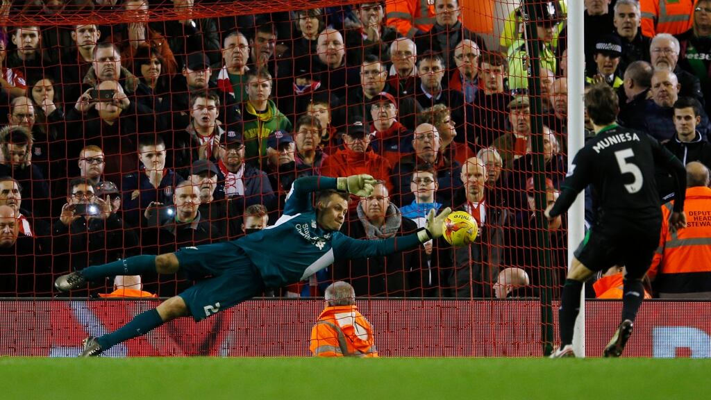 Liverpool goalkeeper Simon Mignolet saves from Stoke City’s Marc Muniesa during the penalty shootout at Anfield. Photograph: Phil Noble/Reuters