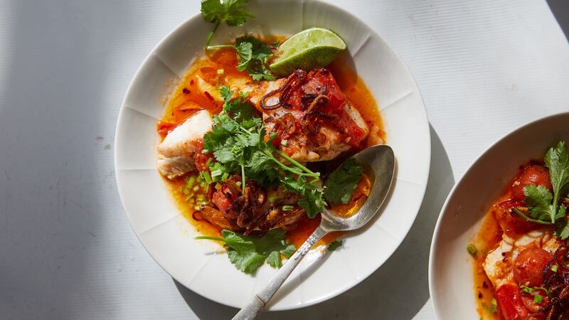 Tomato-poached fish with chilli oil and herbs. Photograph: Michael Graydon & Nikole Herriott/The New York Times.