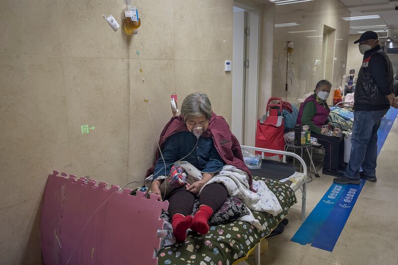 An elderly patient using a ventilator in the corridor of the emergency ward at a hospital in Beijing. Photograph: Andy Wong/AP