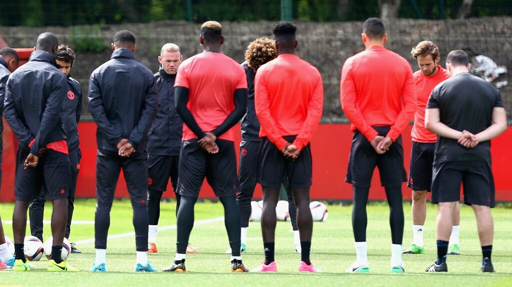 Manchester United players and staff hold a minute silence on Tuesday in memory of the victims of the Manchester concert attack. Photograph: PA
