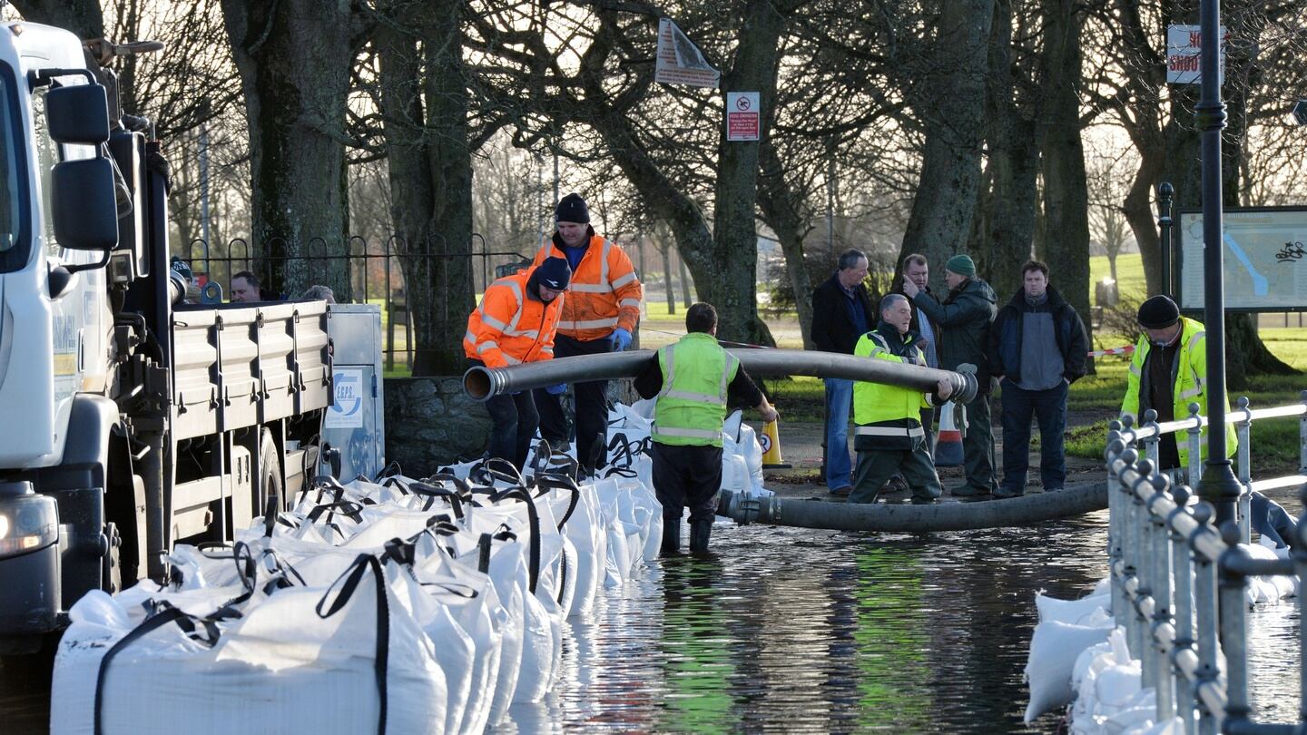 Residents and council members shore up  flood defences on the eastern side of the River Shannon in Athlone Town on Friday in a bid keeping water from homes in the area. Photograph: Alan Betson / The Irish Times