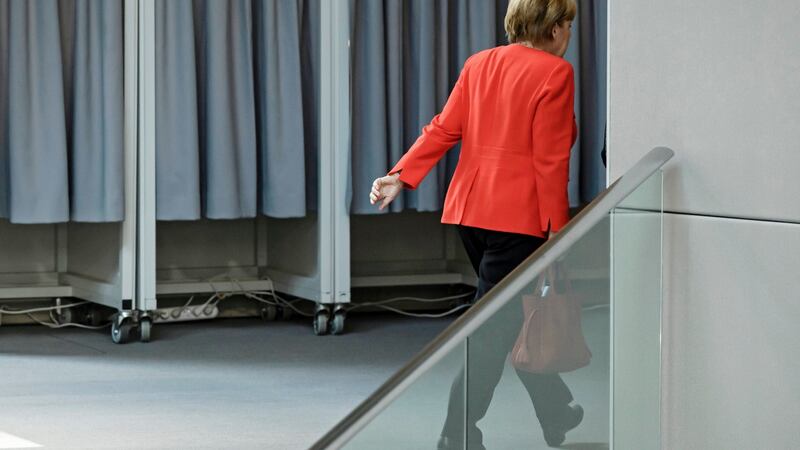 Merkel leaves the plenum during a session of the German Bundestag in Berlin,. Photograph: Clemens Bilan/EPA