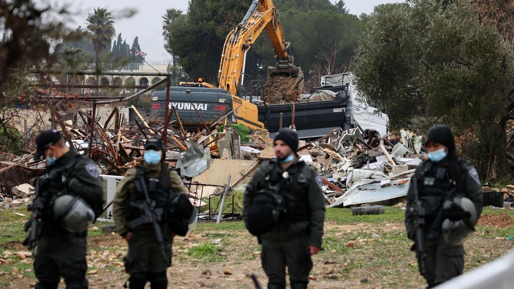 Israeli forces stand guard as machinery clean the ruins of the Palestinian Salhiya family’s house, after it was destroyed by police, in the flashpoint Sheikh Jarrah neighbourhood of East Jerusalem. Photograph: Ahmad Gharabli/AFP/Getty