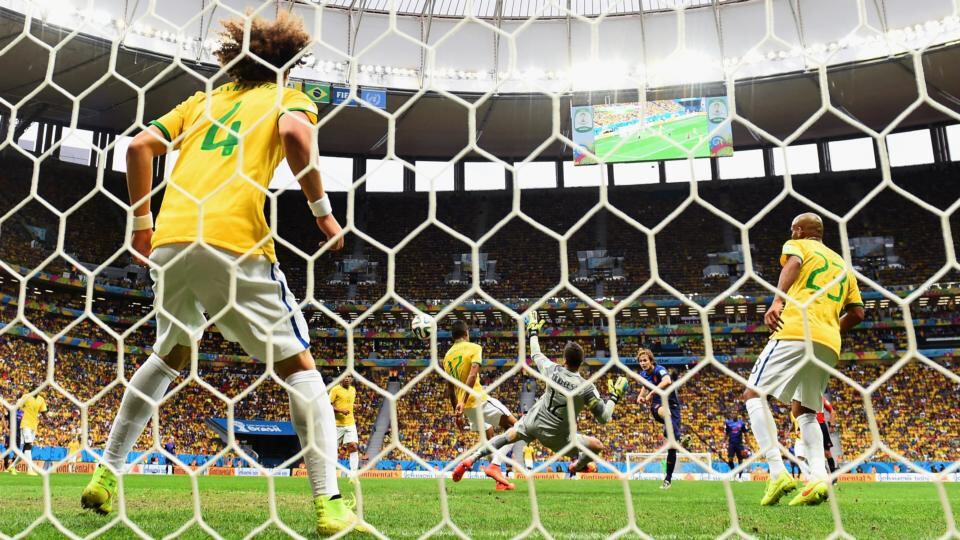 Daley Blind of the Netherlands scores his team’s second goal past goalkeeper Julio Cesar and David Luiz of Brazil. Photograph: Jamie McDonald/Getty Images