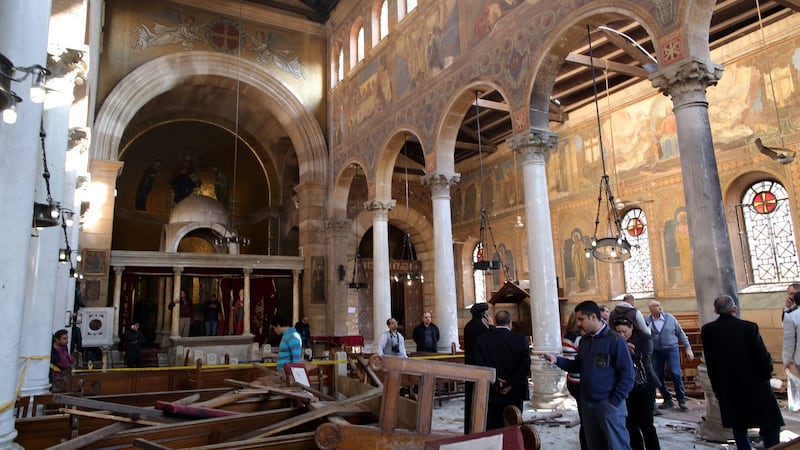 People inspect the damage inside St. Peter and St. Paul Coptic Orthodox Church after a bombing in Cairo on Sunday. The St. Peter and St. Paul church is a small chapel attached to the Coptic Cathedral. Photograph: EPA