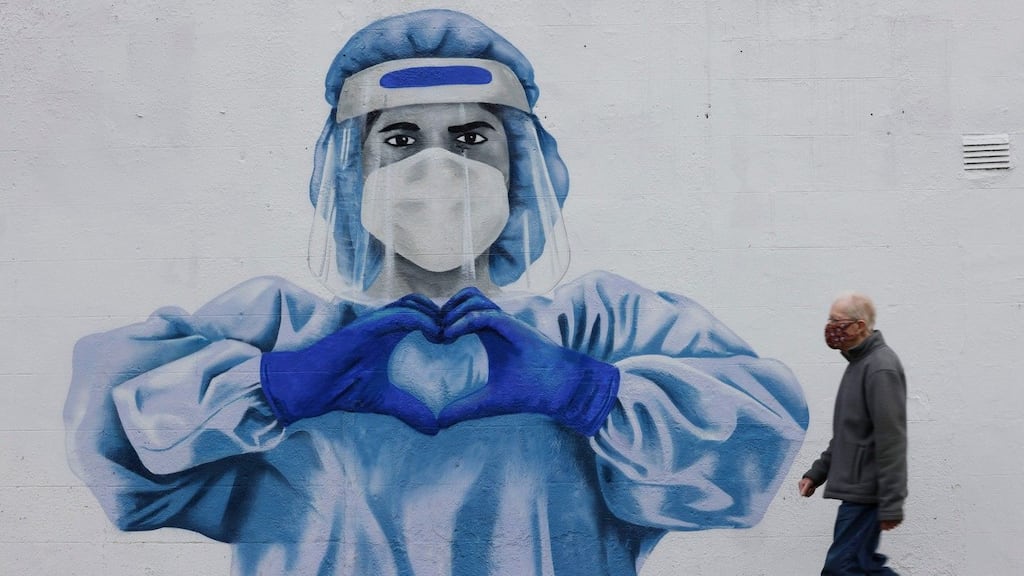 Mural of a healthcare worker in Harold’s Cross, Dublin: Modelling indicates that under pessimistic projections case numbers could rise to more than 12,000 daily. Photograph: Alan Betson