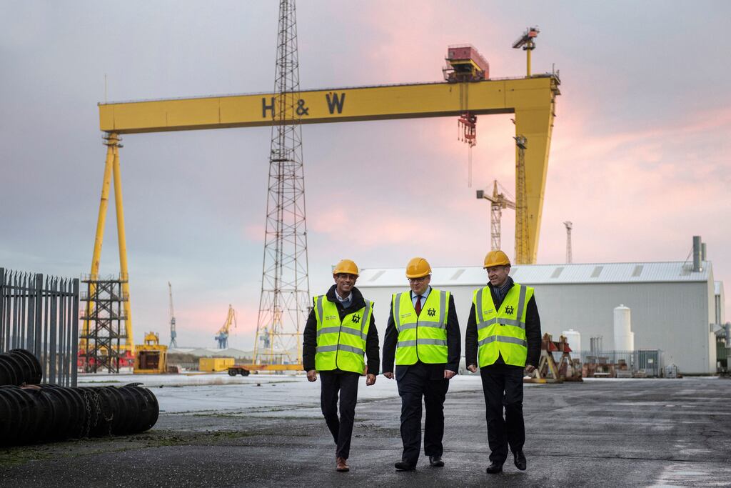 Britain's Prime Minister Rishi Sunak, left, Harland & Wolff chief executive John Wood, and Britain's Northern Ireland Secretary Chris Heaton-Harris visiting the shipyard factory in December. The Belfast shipyard has secured part of a £1.6bn contract for three new British naval vessels. Photograph: Photograph: CHARLES MCQUILLAN/POOL/AFP via Getty Images