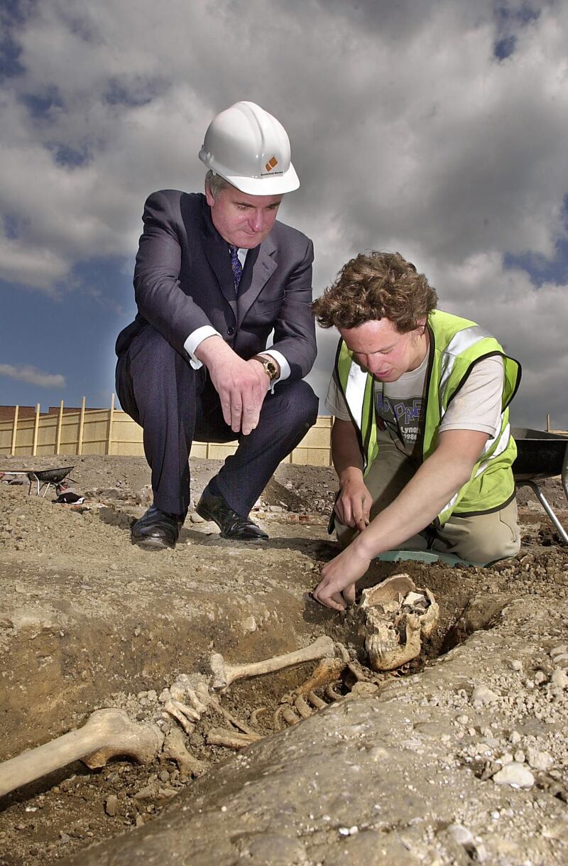 Bertie Ahern, with archaeologist Gary Bedford, and a 16th century skeleton on the site of the Smithfield Market Development. Photograph: Brenda Fitzsimons